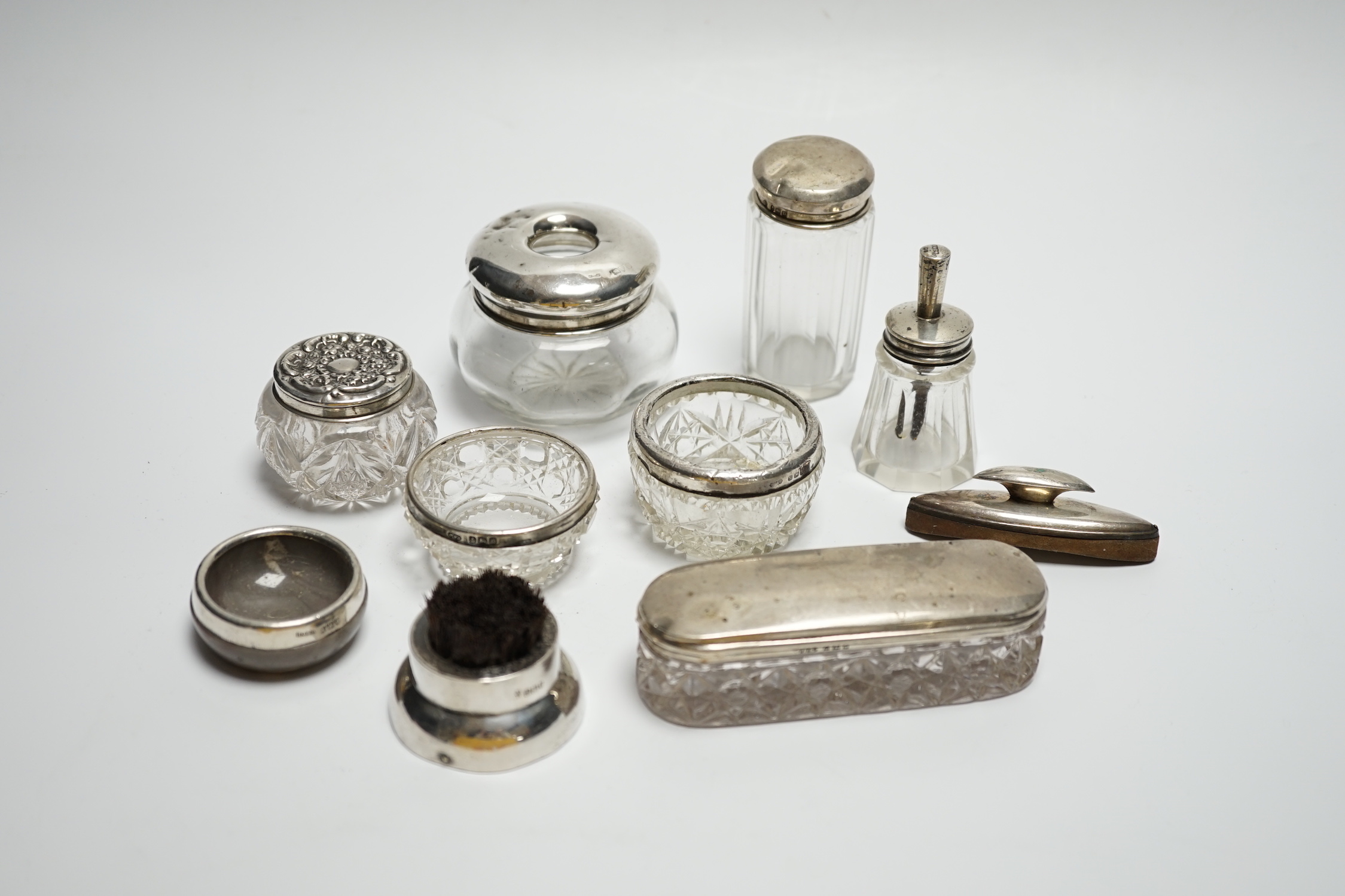 Eight assorted silver topped toilet jars, etc. a silver mounted nail buffer and pen wipe.
